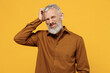 Puzzled thoughtful wistful elderly gray-haired bearded man 40s years old wears brown shirt scratch on temple think lost in thought and conjectures isolated on plain yellow background studio portrait.