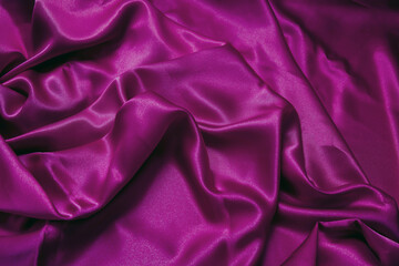 Purple violet silk fabric background, texture. Luxury wavy satin textile for backdrop.