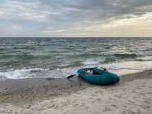 Abandoned Inflatable Rowing Boat At The Beach On A Gloomy Autumn Day