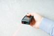 Laser rangefinder or laser tape measure in a male hand. It is a smart device for quick measurement of a distance.
