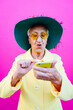 © oneinchpunch - Funny grandmother portraits. Senior old woman, interacting with a smartphone. Concept about seniority