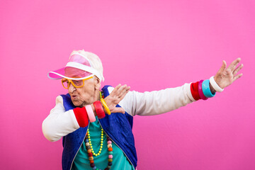 Wall Mural - Funny grandmother portraits. 80s style outfit. Dab dance on colored backgrounds. Concept about seniority and old people