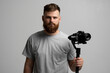 © Volodymyr - Professional videographer using dslr camera on gimbal stabilizer isolated on white background.
