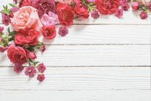 Pink And Red Roses On White Wooden Background
