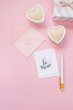 Happy Valentines Day composition. Blank greeting card mockup, gift boxes, hearts, confetti on pink background