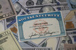Fake Social security card on prop US currency - Concept of Social Security Benefits