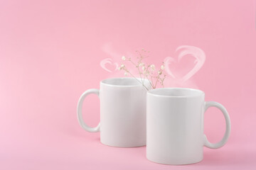 Wall Mural - Mockup white coffe two cups or mug on a pink background with copy space. Blank template for your design, branding, business. Real photo. Hot drink steam in the form of hearts