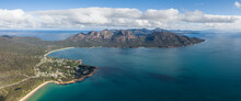 XXL Panoramic High Angle Aerial Drone View Of Coles Bay With Richardsons Beach And Hazards Mountain Range, Part Of Freycinet Peninsula National Park, Tasmania, Australia. Muirs Beach In Foreground