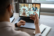 © Stock 4 You - Back view of man having virtual training on video call meeting, online webinar