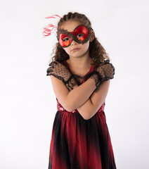 Wall Mural - Beautiful mixed race little girl in glamorous red mardis gras mask and black gloves 