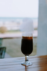 Wall Mural - A vertical shot of a glass of drink on a table