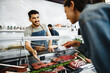 © fotofabrika - Butcher's shop seller helps to choose product to woman customer