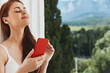 © SHOTPRIME STUDIO - Portrait woman with a red phone Terrace outdoor luxury landscape leisure Lifestyle