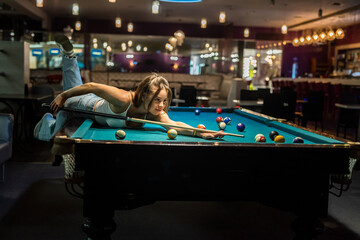 Wall Mural - attractive woman hold cue and playing billiards
