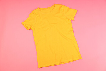 Wall Mural - Yellow t-shirt with space for print on pink background
