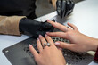 a manicurist in special gloves saws off a new client's nails during an epidemic.