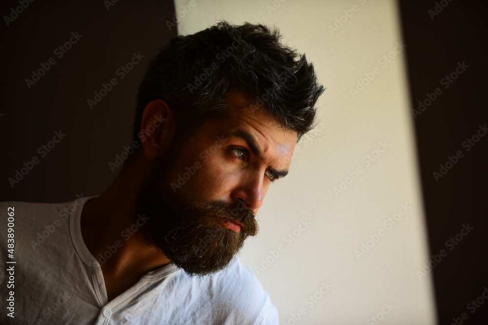 Brutal man, serious face of handsome male model, concept of men power and strong. Shadow male face. Close up portrait of guy with serious profile face.