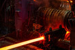 The red-hot metal bar is rolled on a rolling mill