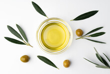 Small Bowl With Olive Oil And Olives On White Background, Top View
