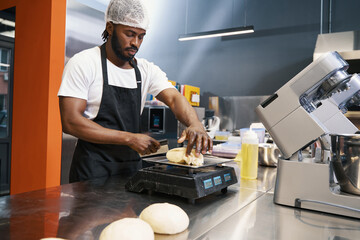 African chef preparing food for baking at the kitchen