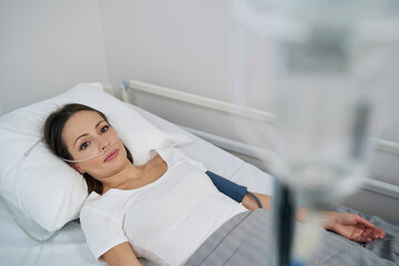 Wall Mural - Young patient receiving medication through IV line