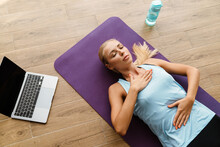 Blonde Young Woman Doing Breathing Exercise During Yoga Practice