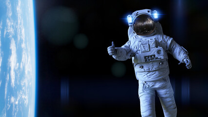 Wall Mural - astronaut showing a thumbs up during space walk in earth orbit background