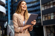 © NDABCREATIVITY - Portrait of successful woman using digital tablet in urban background. Business people concept