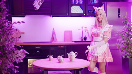 Poster - Cute blonde maid in pink uniform show take a seat gesture to viewer