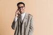 © Drobot Dean - Young middle eastern man in eyeglasses talking on mobile phone