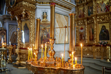 Wall Mural - burning church candles near the altar. Close-up.