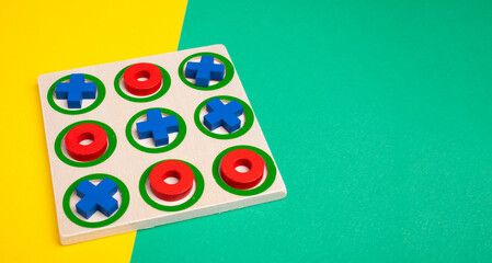 tic-tac-toe board game concept on yellow and green background with copy space