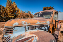 Rusty Old Cars Under A Blue Sky. Old Vintage Vehicles In The Countryside