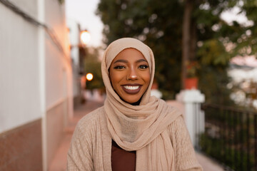 Happy muslim woman smiling at the camera outdoors