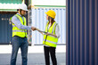 © NVB Stocker - Caucasian Man manager and woman Supervisor dock cargo handshaking after good deal at container yard port of import and export goods. Unity and teamwork concept