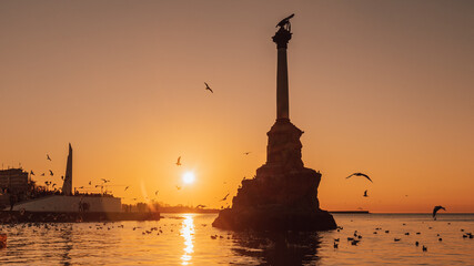 Wall Mural - Monument to sunken ships in Black sea water on sunset. Sevastopol, Crimea