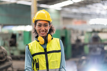 Portrait Of Female Engineer In Safety Vest With Yellow Helmet Smiling Stand To Work At Factory Industrial