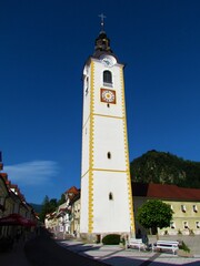 Church tower in Kamnik, Slovenia lit by sunlight