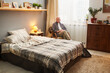 © pressmaster - Portrait of senior man sitting on armchair and looking at camera, he resting in his bedroom
