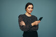 © Jacob Lund - Young woman using a mobile phone in a studio