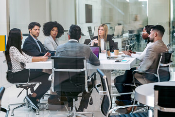 Business people discussing together in conference room during meeting at office in a modern startup.