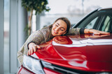 Fototapeta  - Beautiful woman hugging a car