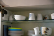 Plates and cups in a kitchen cupboard