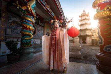 Portrait smile Cute little Asian girl wearing Chinese costumes decoration for Chinese new year festival celebrate culture of china at Chinese shrine Public places in Thailand