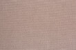 Texture of beige knitted sweater fabric.