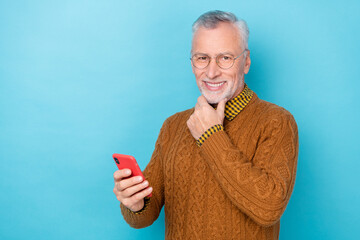 Photo of thoughtful man use smart device decide blog post comment isolated blue color background