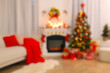 © New Africa - Blurred view of festively decorated room with Christmas tree, fireplace and sofa. Interior design