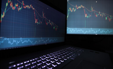 Poster - Laptop screen with stock market charts. Technical analysis and fundamental indicators of stock quotes in the trading terminal. Japanese candlesticks and company tickers.