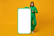 © Damir Khabirov - Happy young woman standing and showing blank screen of huge phone, mock up for your app