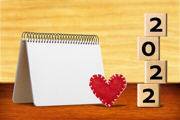 Canvas Print - 2022 cubes with red heart shape and empty notebook on table, Love and Happy Valentine day concept